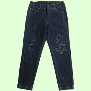 🦝 M,A pair of dark blue jeans with a distressed look and Bart Simpson graphics.